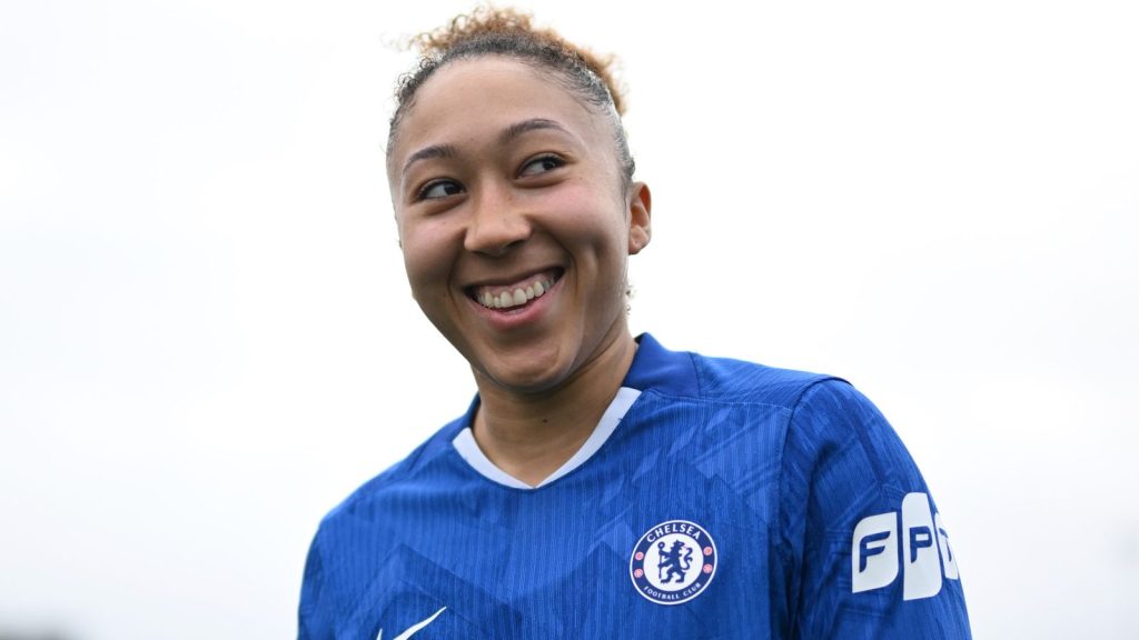 Lauren James poses in a Chelsea shirt